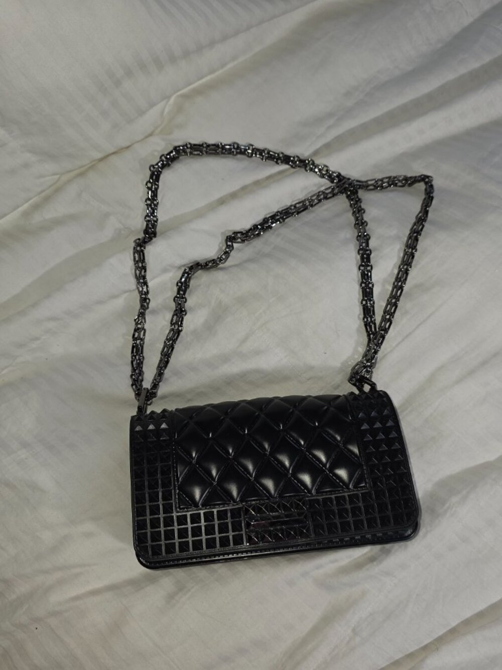Black textured crossbody bag with chain strap